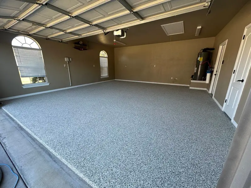 Two-car garage with a blue-gray flake epoxy floor