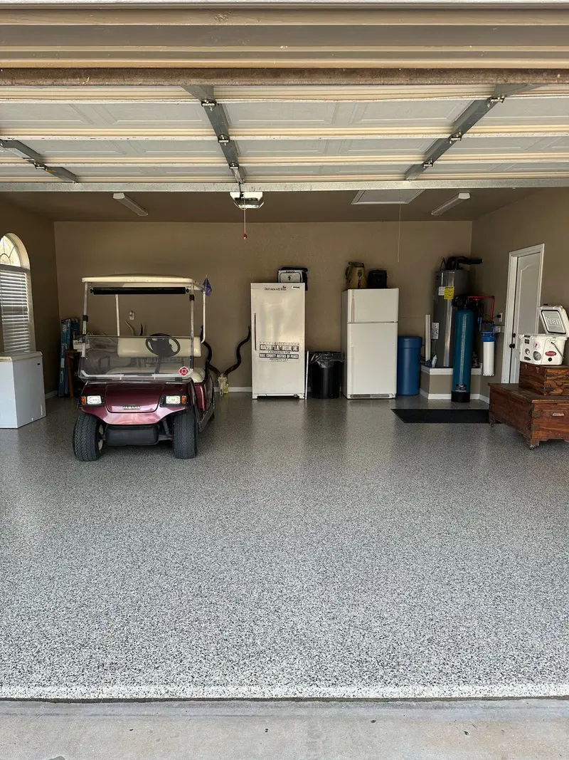 Finished flake epoxy garage floor with a golf cart and refrigerators