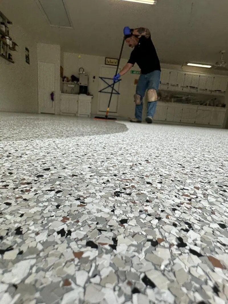 NES Flooring crew member rolling out a polyaspartic topcoat